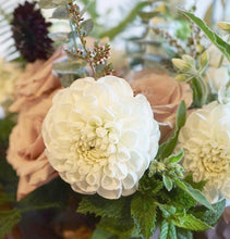 Summer bouquet with white and blush pink flowers and lots of greenery