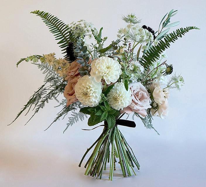 Summer bouquet with white and blush pink flowers and lots of greenery