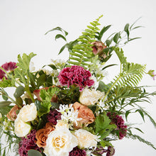 A flower jar bouquet full of seasonal flowers in shades of cappuccino, raspberry and scarlet with pops of white and lots of greenery.