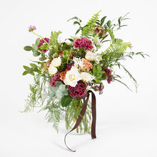 A flower jar bouquet full of seasonal flowers in shades of cappuccino, raspberry and scarlet with pops of white and lots of greenery.